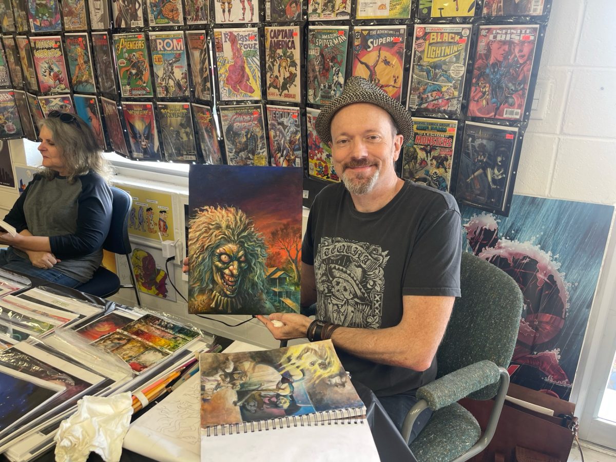 Brian LeBlanc shows off artwork of the painting that became the cover of Mississippi Macabre.