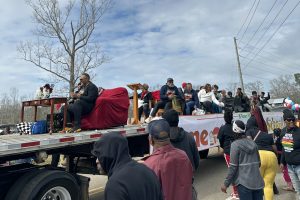 A trailer adorned with the message, "Home, School, and Church," leads the Knobtown Black History Parade on February 22, 2025.