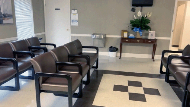 The Hall Health lobby provides a quiet, accessible waiting area for patients. The clinic emphasizes short wait times and longer appointments as part of its membership-based care model.