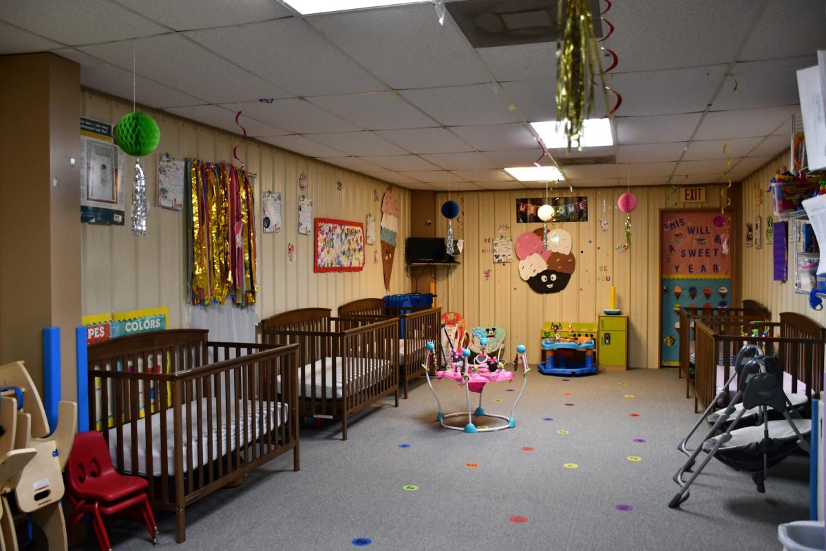 Cribs and toys line the walls of Bettie’s infant room. Like other classrooms in the center, the nursery operates under strict state child-to-staff ratio limits — which affects how many children the facility can enroll.