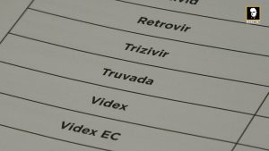 Close-up of a printed list showing names of HIV medications, including Truvada, Retrovir, and Videx.