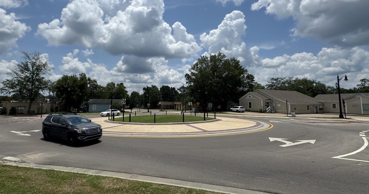 A vehicle navigates the roundabout on Hardy Street near downtown Hattiesburg on June 27, 2025. Despite claims that roundabouts offer no safety benefits, federal reports show they significantly reduce crash severity and frequency compared to traditional intersections.