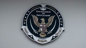 Pearl Public School District emblem on a wall features an eagle, two swords and the motto “Excellence in Education.”