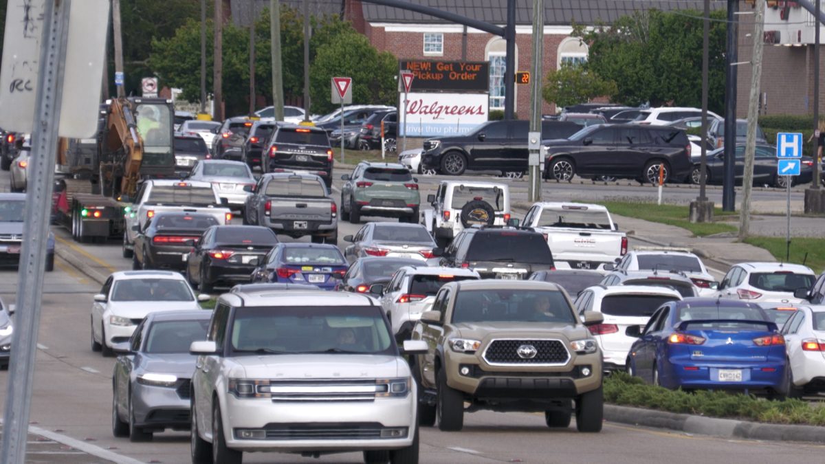 Heavy traffic on U.S. 98 in Hattiesburg, Mississippi, with cars, trucks and SUVs filling multiple lanes near a Walgreens.