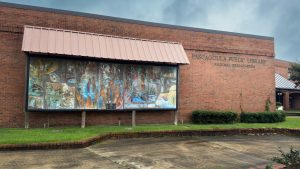 A brick building with a painted mural.