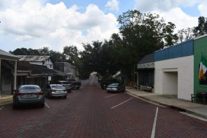 Outside shopping area with a paved brick road in Downtown Wiggins.