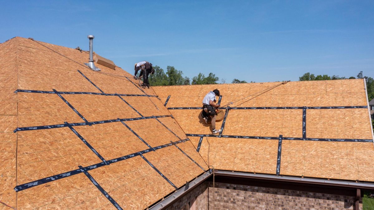 Construction workers install a new roof.
