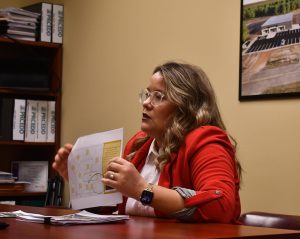 Lindsay Ward holds up site plans while discussing job and industry opportunities tied to the Pearl River County Technology Park.