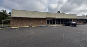 A tan brick storefront with large front windows and a small parking area will become the new Poplarville Post Office. The building once housed a Ramey’s Grocery Store.