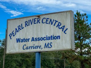 A weathered sign reads “Pearl River Central Water Association, Carriere, MS.”