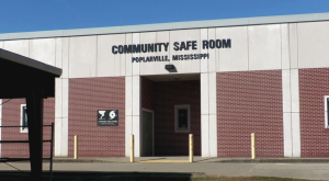 Exterior of the Poplarville Community Safe Room, a brick and concrete building with a sign reading “Community Safe Room – Poplarville, Mississippi.”