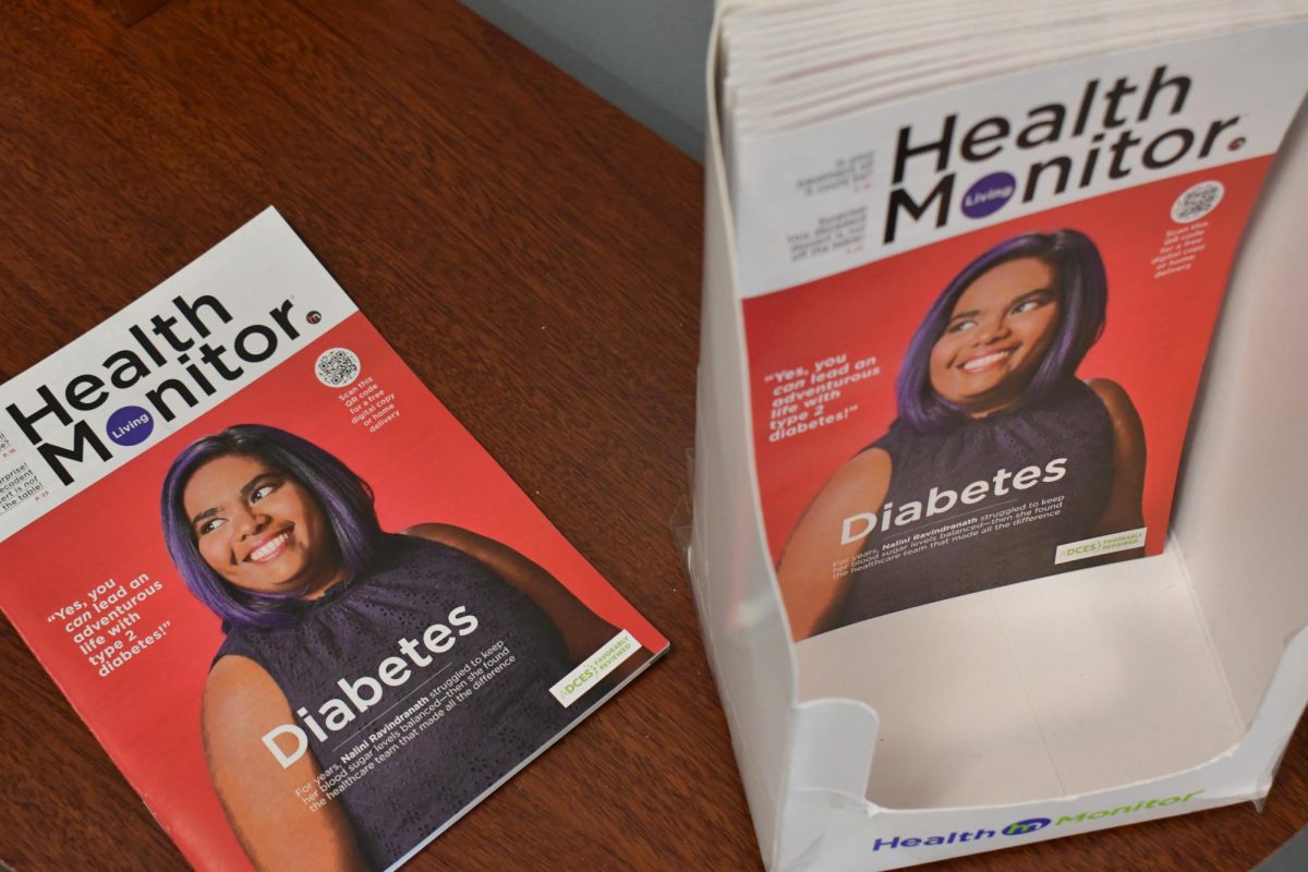 Cover of a Health Monitor Living magazine featuring a woman in a black shirt against a red background.
