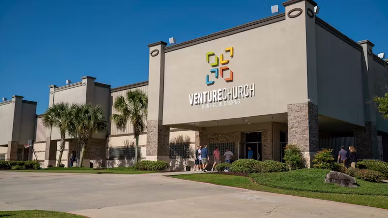 Palm trees line the front entrance of Venture Church’s Hunt Club campus as members walk into the building.