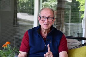 Jan Vest gestures while seated.