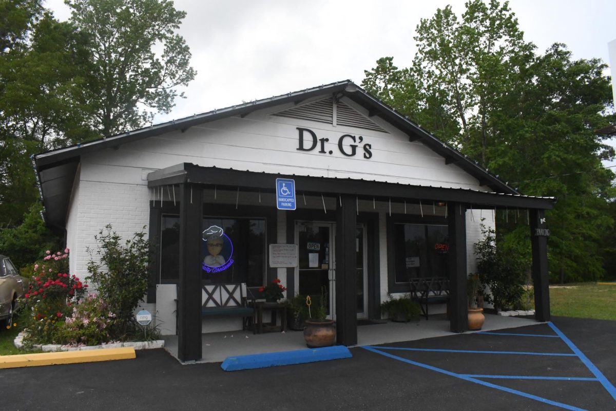 A building with a sign reading “Dr. G’s” sits in front of trees.