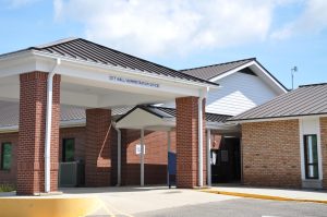 A covered walkway leads to the entrance of Diamondhead City Hall and administration offices.
