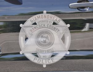 A Diamondhead Police logo is displayed on the side of a vehicle.