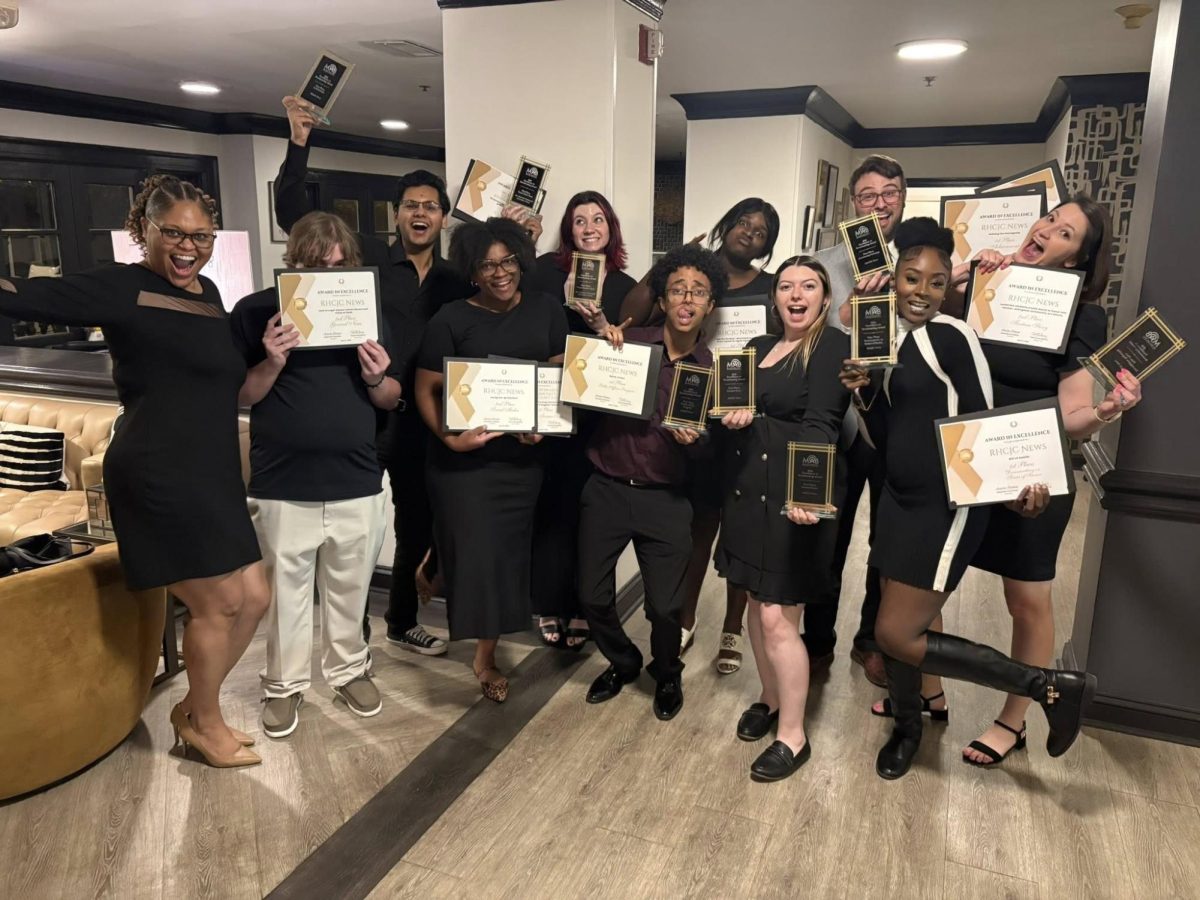 Eleven members of the Roy Howard Community Journalism Center stand indoors holding plaques and certificates after the center won 18 awards at the Mississippi Association of Broadcasters’ 2026 Excellence in Broadcasting Awards.