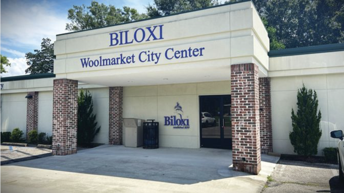 A building sign reads “Biloxi Woolmarket City Center” in dark blue letters.