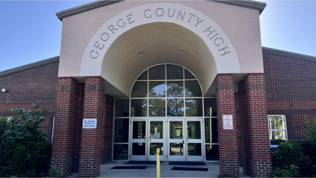 The front entrance of George County High School is shown under a large arched sign.