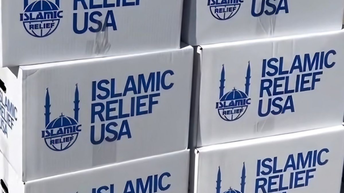 Stacked white food boxes with the Islamic Relief USA logo are prepared for community distribution.