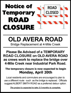 A printed notice announces a temporary road closure on Old Avera Road for a bridge replacement project at Four Mile Creek.