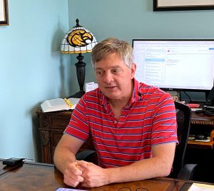 State Sen. Joey Fillingane sits at a desk during an interview.