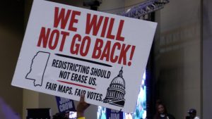Poster with graphic of Mississippi and a government building. Text reads in all caps: “We will not go back! Redistricting should not erase us. Fair maps. Fair votes.”