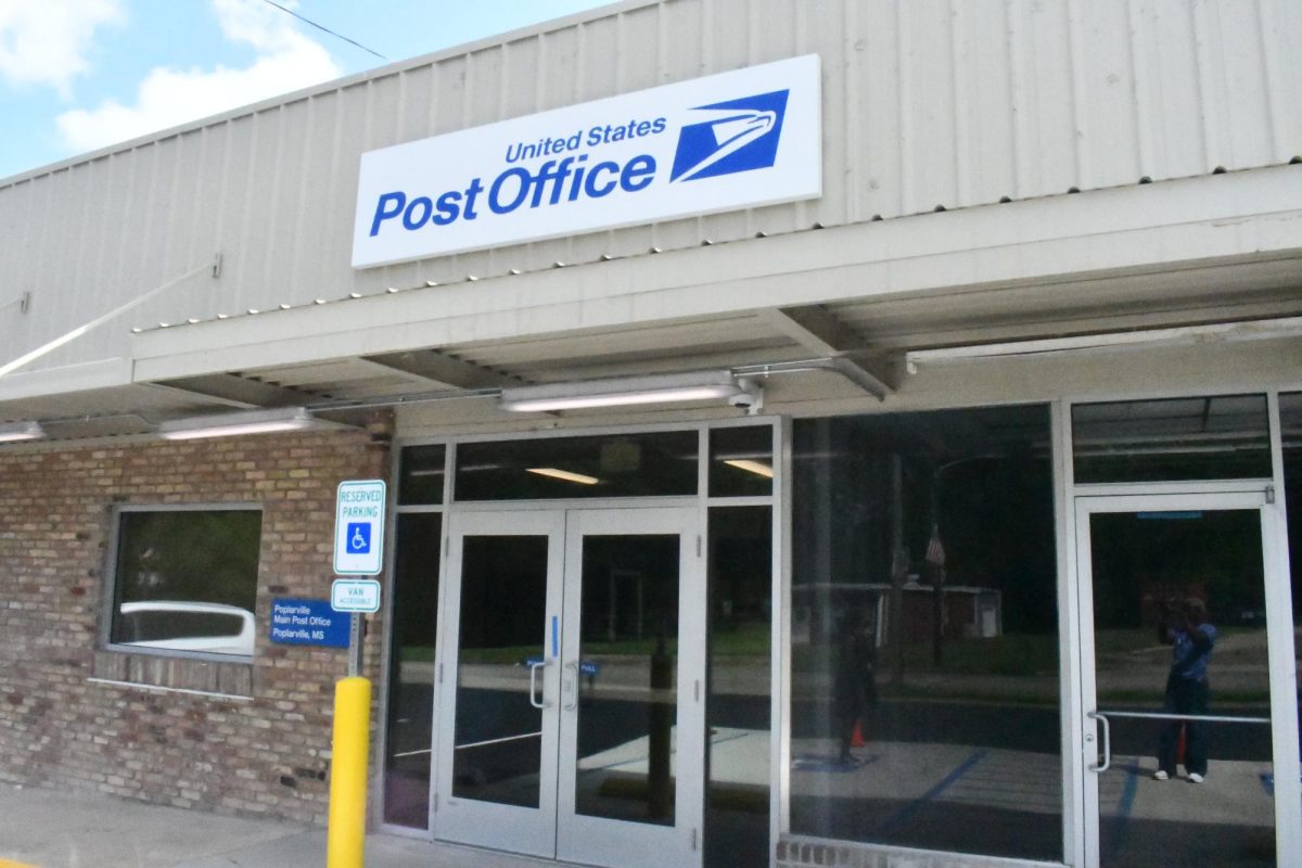 Entrance to the new Poplarville Post Office in the former Ramey's shopping center with blue-and-white USPS signage above the front doors.