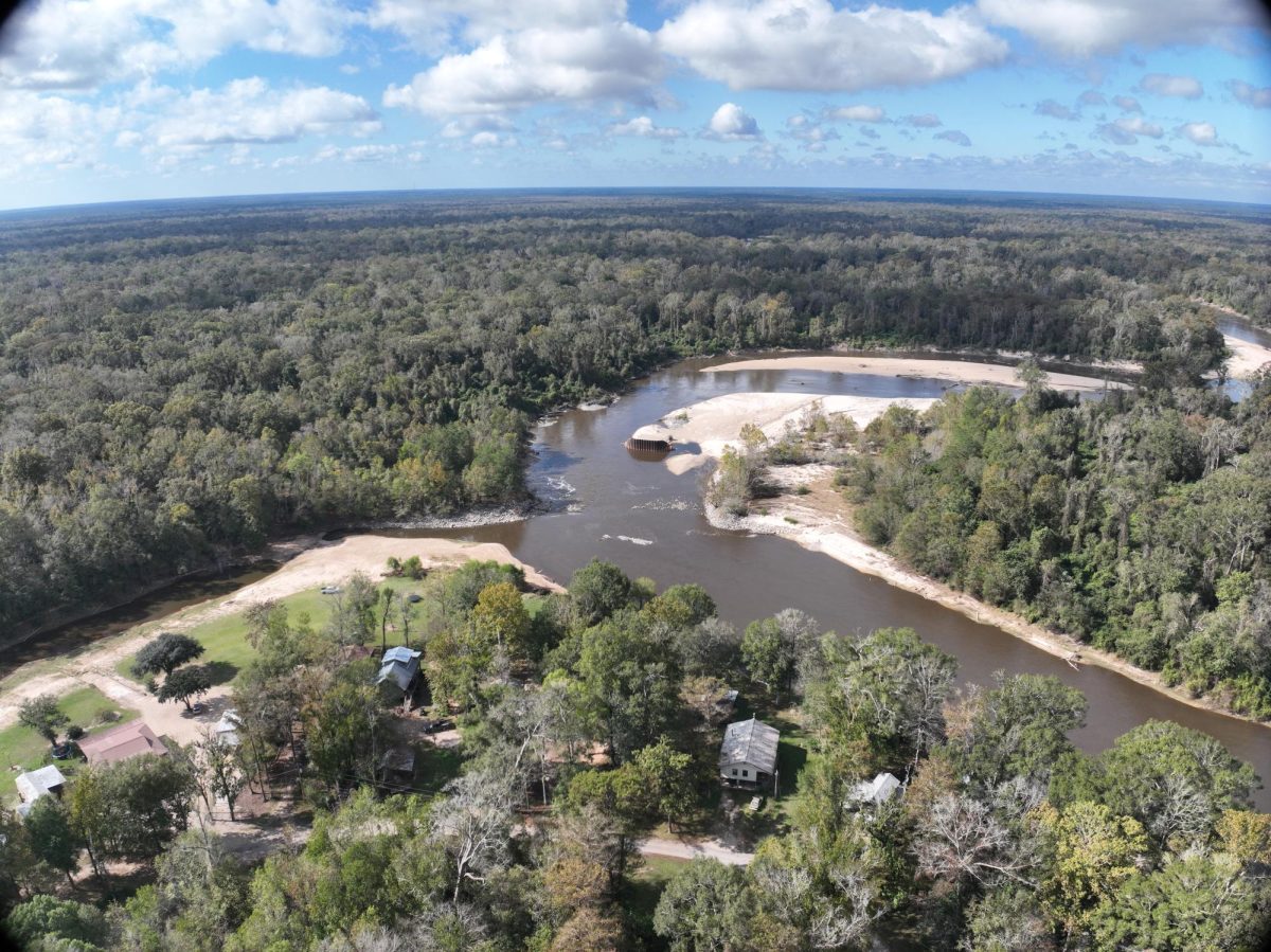 Aerial view of the Walkiah Bluff Weir on the East Pearl River, with sandbars, shallow water and several homes along the riverbank.