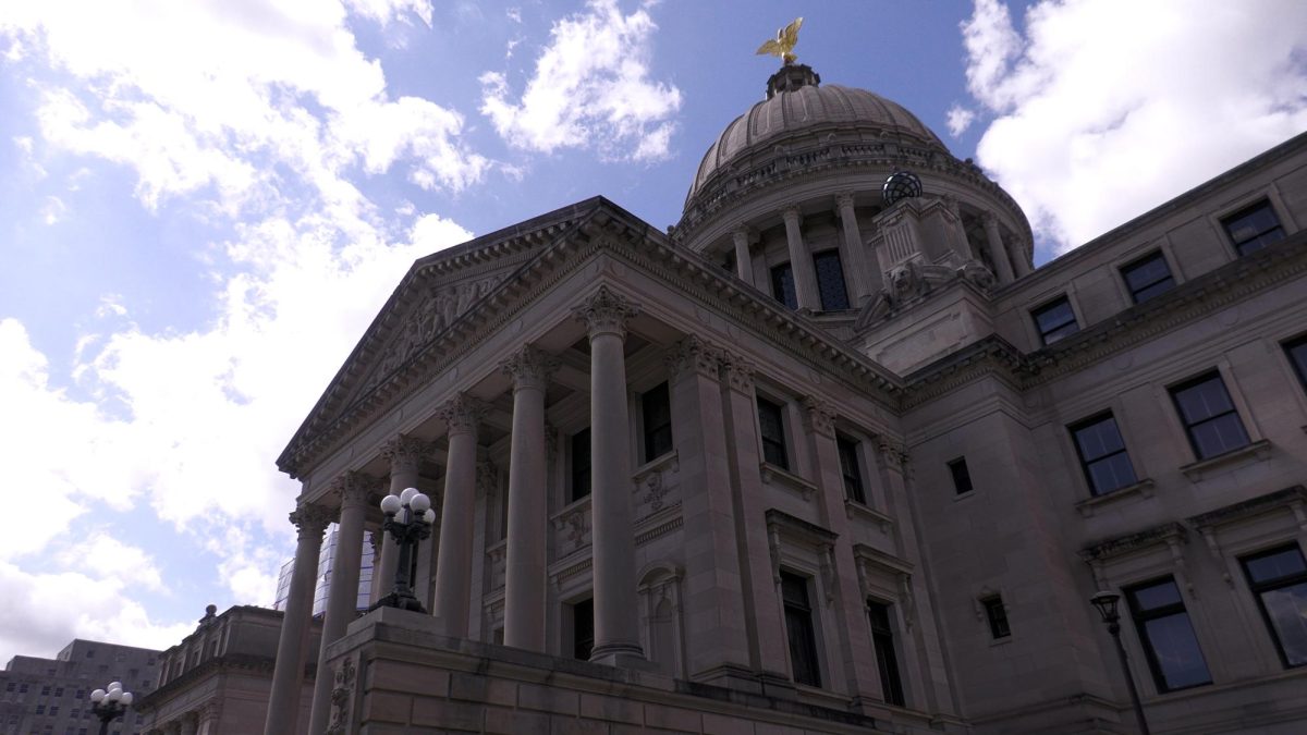 A domed marble building topped with a golden eagle statue.